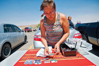 Jeweler Cassandra Little lays out her goods at the flea market in Window Rock on Saturday. © 2011 Gallup Independent / Cable Hoover 